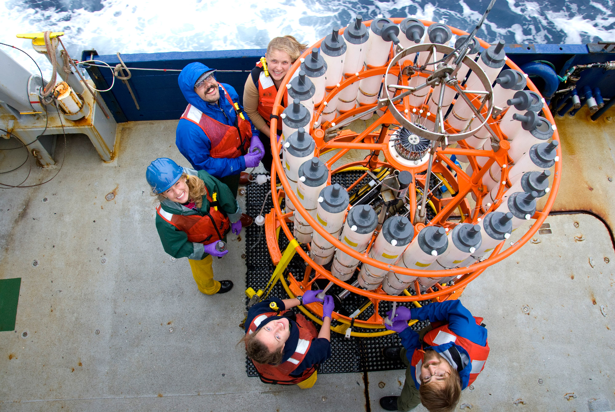 Researchers on deck preparing a CTD rosette for deployment.